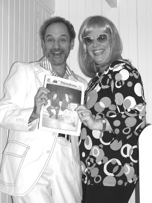 021705
Kathy Goulart and Greg Galvan pose in their 70s garb with a copy of The Wanderer at the recent Dana Farber Cancer Benefit Dance held at the Knights of Columbus Hall on Route 6 in Mattapoisett on Saturday, February 12. The event, which featured classic 70s and 80s music, raised over $5,000 that will go directly for cancer research and treatment. (Photo by Michael Immel). 2/17/05 edition
