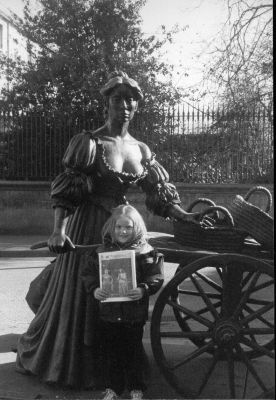 03-15-01
In Dublins fair city / Where the girls are so pretty / I first set my eyes on / Sweet Molly Malone. Five-year-old Troina Cuddy of Mattapoisett meets Molly Malone herself on a recent trip to Irelands capital city, and here she poses in front of a monument to the legendary lass with a copy of her favorite reading material. 3/15/01 edition
