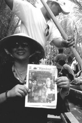 040705-3
Mattapoisett native Toya D. Gabeler poses with a copy of The Wanderer in a canal on Unicorn Island in Mytha (Mekong Delta) in Vietnam during a recent trip. (Photo courtesy of Toya D. Gabeler). 4/7/50 edition
