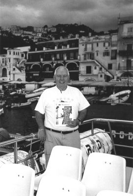 051503-3
Dr. C. A. Tavares of Mattapoisett poses with a copy of The Wanderer on the Isle of Capri during a vacation.5/15/03 edition
