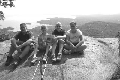 090904-2
Jamie and Hailey Gallagher of Rochester pose with a copy of The Wanderer alongside cousins Meagan Smith and Nick Nelson on the summit of  Mount Megunticook in Camden Maine, the highest mainland mountain on the Atlantic coast. (Photo by and courtesy of Jill Gallagher). 9/9/04 edition
