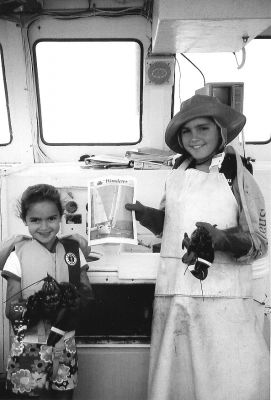 112504-1
Hallie and Jack Thomas of Mattapoisett pose with a copy of The Wanderer while recently learning how to catch a lobster aboard the Lucky Catch, a working lobster boat out of Casco Bay in Portland, ME. (Photo by Sandy Thomas). 11/25/04 edition
