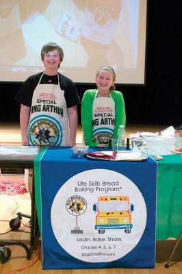 How Bread is Made
Sixth-graders Nathaniel King (left) and Julia Winters (right) pose at the work table before lending a hand to a special assembly organized by King Arthur Flour that teaches students the scientific nitty-gritty of how bread is made.  Winters had visited the flour company’s headquarters in Vermont last year and thought this program would benefit her fellow students.  She and her mother helped bring the program to the Tri-Town.  Photo by Eric Tripoli.
