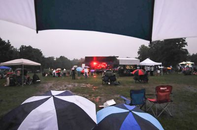 Billy Joel Tribute 
“Falling of the Rain,” may not be the biggest hit of Billy Joel produced but the Billy Joel Tribute at Silvershell beach on Saturday had no shortage of falling rain. Dozens of die hard supporters showed up despite the rain to help support the Marion Police Brotherhood and to hear the “Eric Robert: Billy Joel Tribute.” It must be true, “you can’t stop the falling of the rain!” or stop the fans. Photos by Felix Perez.
