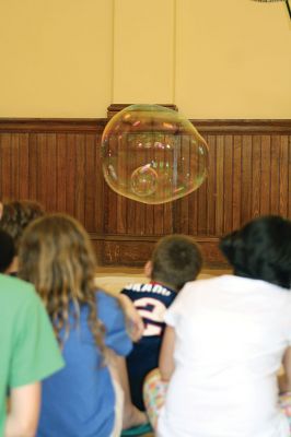 Bubbles, bubbles, everywhere! 
Kids were spellbound by Keith Johnson and his “Bubbleology” show at the Marion Music Hall on June 22, sponsored by the Elizabeth Taber Library. Ty Mackenzie, 9, was the lucky one who got to be swallowed up by a giant bubble. Photos by Jean Perry

