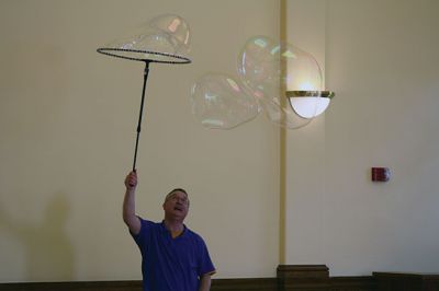 Bubbles, bubbles, everywhere! 
Kids were spellbound by Keith Johnson and his “Bubbleology” show at the Marion Music Hall on June 22, sponsored by the Elizabeth Taber Library. Ty Mackenzie, 9, was the lucky one who got to be swallowed up by a giant bubble. Photos by Jean Perry
