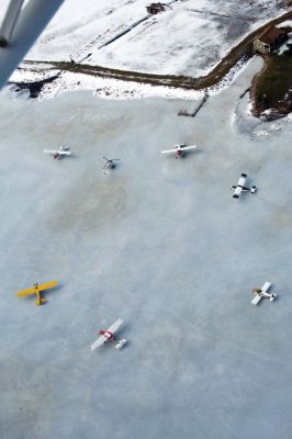 Frozen Flyers
A group of South Coast pilots recently took advantage of this winters cold conditions to use Snipatuit Pond as a landing strip. The pilots use charts provided by the United States Government to determine if the thickness of the ice is enough to support the weight of their airplanes. Pilot Ben Bailey, who lives on the shores of the pond and hosted this past weeks get together, fl ies a seaplane off of the pond during warmer weather months. Photo by Robert Chiarito. February 12, 2009 edition
