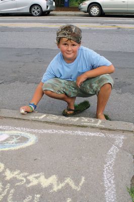 Chalk It Up
The day before the Marion Town Party, kids chalked-up the sidewalks in front of the Marion Town House in preparation for the Saturday night event. Town Party Planning Committee members set up picnic tables and strung party lights in the background while the kids drew colorful, festive pictures with chalk. Photos by Jean Perry
