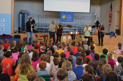Manguito
Center School students were introduced to Latin rhythms and percussion instruments by the Boston-based educational Latin American music group Manguito during an afternoon presentation on January 24. Manguito members really captured the attention of the kids, resulting in plenty of learning while the group’s sizzling salsa and merengue music resulted in an eruption of dancing and spontaneous conga lines. Photo by Jean Perry
