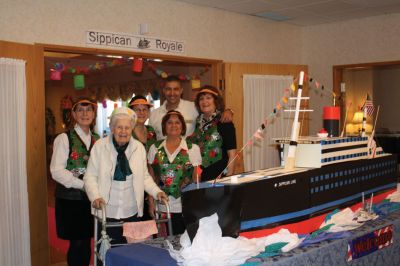 Sippican Royale
Staff and residents enjoy the handmade ship created for the cruise week at Sippican Healthcare Center in Marion.  Volunteer Tom Lynch made the ship out of cardboard egg cartons. Photo by Joan Hartnett-Barry
