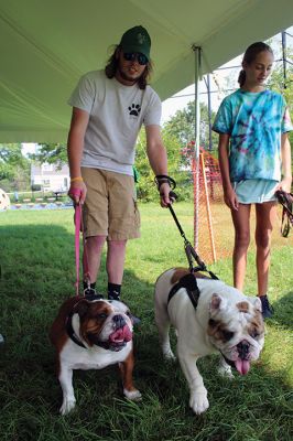 Dog Walk Fundraiser
Freemin Bauer with his five-year-old sibling bulldogs Mia and Louie during Saturday’s dog walk fundraiser held at Center School in Mattapoisett. Six years ago, Bauer was an eagle scout who donated his first dog-walking fundraising collection to an animal shelter in Fairhaven. Approximately 20 dogs were on hand for the August 28 event, a small step in a larger effort to finance a dog park in town. According to Mattapoisett Select Board member Jodi Bauer
