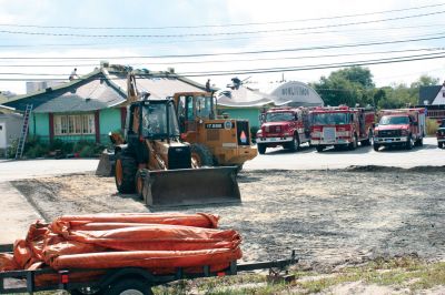 Fall Clean-up
The Mattapoisett Highway Department spent last week resurfacing the Fire Department driveway while in the background the Cathay Temple building received a new roof. Photo by Anne OBrien-Kakley
