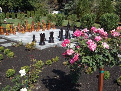 Gardens by the Sea
 This larger than life-sized chessboard surrounded by roses is just one of the unique gardens featured in St. Gabriel’s Church and the Garden Club of Marion’s garden tour titled, “Gardens by the Sea” on Friday, July 11th. This garden belonging to one Garden Club member was inspired by J.K. Rowling’s Harry Potter series. Photo by Jacqueline Hatch. 
