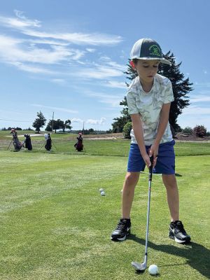 Golf Training
Young golfers from a group of 55 attending three training sessions last week take aim under the watchful eye of volunteers. Photos courtesy Paul Jellison
