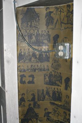 Historic Fire
Vintage wallpaper depicting Victorian scenes lines an alcove in the upstairs of the house. The wallpaper is badly damaged by soot and will probably have to be removed.
