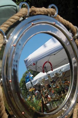 Reflecting on Harbor Days 
Mirror, mirror, on the ground, what’s the fairest event around? This nautical mirror for sale at Harbor Days on Saturday reflects the general splendor of the annual Mattapoisett event as shoppers fill the many aisles of various arts and crafts vendors, looking to see what’s new and what’s traditionally found at Harbor Days year after year. Photo by Jean Perry
