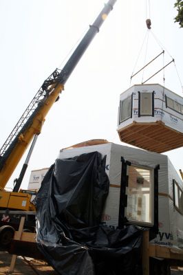 Instant House
A crane hoists one of the six sections that will make up the home into place. Photo by Paul Lopes
