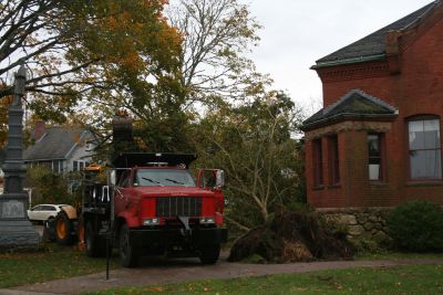 After Sandy
Clean-up crews work to remove a fallen tree in front of the Marion Music Hall on Front Street Tuesday afternoon.  The tree was ripped out of the ground from the strong gusts of Hurricane Sandy, which tore through the South Coast on Monday. The Music Hall didn’t sustain any damage.  Photo by Katy Fitzpatrick.
