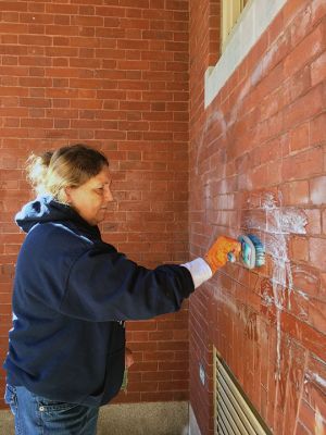Mattapoisett Select Board
Mattapoisett Select Board member Jodi Bauer, along with Historical Commission Chair Rachel McGourthy and Secretary Margaret DeMello attempted to remove graffiti from the historic, brick facade of Center School on October 22. Vandals had defaced the façade some time ago. Photo by Marilou Newell
