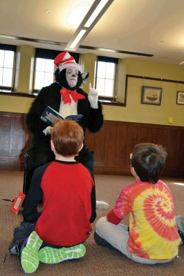 Mattapoisett Free Library Birthday
“Say Triskaidekaphobia!” the Cat in the Hat told the children, posing for a photo at the Mattapoisett Free Library on Saturday, March 22. What the heck is that, the children asked the Cat in the Hat. “Google it!” he told the children laughing at his silliness. The library knows how to throw a party, celebrating five years since the Friends of the Mattapoisett Library funded the expansion of the library. “They even bought a cake,” said Children’s Services Librarian Sandra Burke.  By Jean Perry
