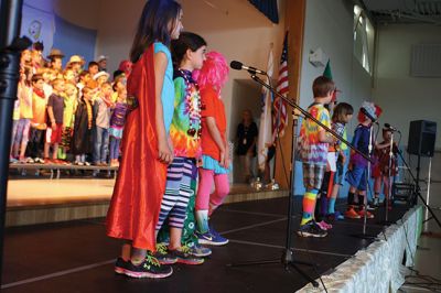 Lighten Up
Third-graders on June 16 performed their play “Lighten Up,” donning rainbow wigs, gigantic glasses, tutus, and brightly colored mustaches to remind everyone to not take themselves so seriously all the time. The students sang silly songs, told jokes, and offered some valuable advice like, “When life makes you sweat, wear deodorant!” By Jean Perry
