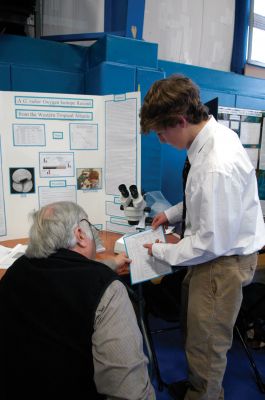 Science Fair
Luke Johns of Mattapoisett is pictured with a judge from the Falmouth Academy Science Fair. Mr. Johns won second place in the grades 9 through 11 for his project A G. ruber oxygen isotope record from the western tropical Atlantic." Photo by Susan D. Moffat.
