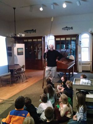 Marion Natural History Museum
Dr. Michael Moore of Woods Hole Oceanographic Institute, using the museum's harpoon and baleen, introduced the Marion Natural History Museum's after-school group to a little of Marion's whaling history. Students could ask questions and theorize why Sippican Harbor had the first recorded visit from a humpback whale this fall. We wish to thank Dr. Moore for the great program. Photo courtesy Elizabeth Leidhold
