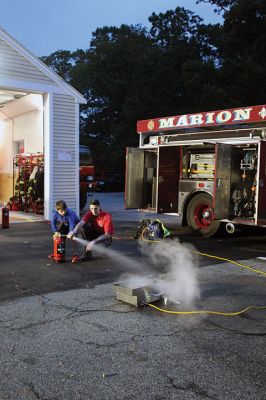 Marion Fire Department 
The Marion Fire Department held an open house on Friday evening. Older children learned how to use fire-extermination equipment, and younger ones enjoyed the bouncy house and a meeting with mascot Sparky. Photos by Mick Colageo
