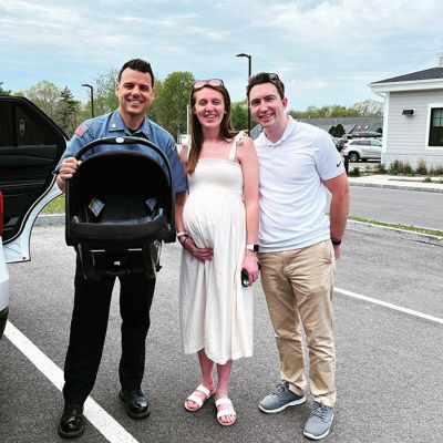 Infant Car Seat
Mattapoisett Police Officer Adalberto Cardoso Jr. helps teach the new soon-to-be parents Trevor and Sarah Oldham how to properly and safely install and use their infant car seat for their little one due in four weeks. Submitted by Betsey Oldham
