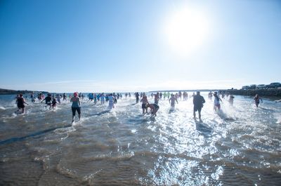 Freezin' for a Reason 2014
Participants in the 2014 Polar Plunge on January 1 were encouraged to wear costumes for the event, which raised thousands of dollars for the BAM Foundation. BAM is an organization that offers financial assistance to families battling cancer to help offset the unexpected costs of cancer treatment. Hundreds of people turned out for the event, with over a hundred participants who plunged into 34 degree waters, just a few degrees warmer than the 28 degree air temperature that morning.  Photo by Felix Perez
