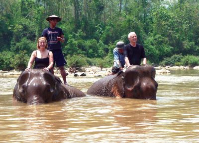 Sippican Woman's Club 
Marion residents Harry Norweb and Pam Norweb spoke about their six-week trip to Asia at the Sippican Woman's Club meeting on January 13. Pictured here, the Norwebs enjoy an elephant ride along the Mekong River in China. Photo courtesy of Harry Norweb.
