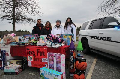 ORR Toys for Tots 
A Toys for Tots collection was held on December 10 at Old Rochester Regional High School. Volunteers on site, from left: Mattapoisett Police officer Junior Cardoso, co-advisor Andrea Moniz, and ORR students Kaya Savaria of Rochester and Beverly Morse of Marion. Not pictured: co-advisor Karen Browning. Photo by Mick Colageo
