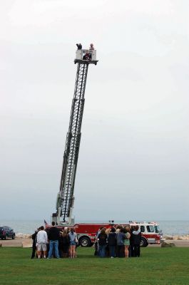 Class of 2011
Photographer Antoinette Pacheco sits atop the Marion FD Ladder Truck with Lt. Ronald Auld as she gets an aerial photo of the 185 ORR seniors forming the number "11" for the 2011 ORR yearbook. Photo courtesy of Debra Cordeiro. October 7, 2010 edition
