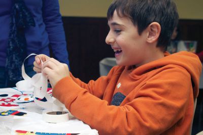Holiday Ornaments
Elliot Staple smiles as he creates a popsicle stick nutcracker ornament at the Mattapoisett Library youth ornament-making activity on Saturday, December 15..  Photo by Eric Tripoli.
