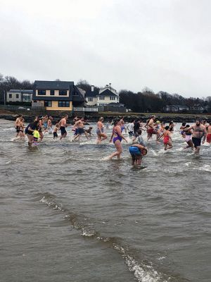 New Year Plunge
It was not publicized or heavily promoted, but traditions are hard to break. That was the case on New Year’s Day 2022 when a hearty group of some 200 “plungers” arrived at Mattapoisett Town Beach for their annual dip in the harbor. Last year the event was not publicized at all, said this year’s organizers, Heather and Michael Bichsel. “But we decided since people were going to show up anyway, we’d help to keep this going.” 
