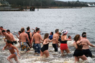Christmas Day Swim
On Christmas Day 2014, about 50 hardy souls, young and old alike, ran with yelps of joy into 42-degree winter waters at Mattapoisett’s Town Beach. This annual event raises funds for Helping Hands and Hooves, a nonprofit organization in Mattapoisett that provides horseback riding lessons and therapeutic sessions for people with special needs. Photos by Marilou Newell

