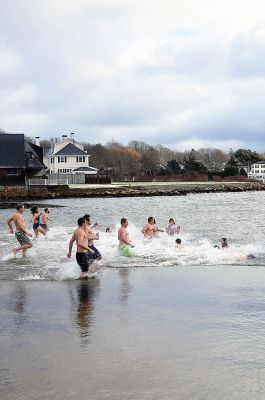 Christmas Day Swim
The Helping Hands and Hooves’ annual Christmas Day Swim was preceded by a polar plunge in the weather and a brief ‘snownado’ of sorts as the winds swept snow and sleet across the area only minutes before enthusiastic participants in costume arrived at the Mattapoisett Town Beach and raced into the icy waters. Photos by Glenn C. Silva
