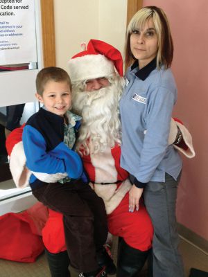 Post Office Santa
On Saturday, December 15, Santa took the time out of his busy schedule to visit the Rochester Post Office.  Cody Barrows, left, and Sandy Polonio, right, pose with Jolly Old Saint Nick.  Photo by Katy Fitzpatrick.
