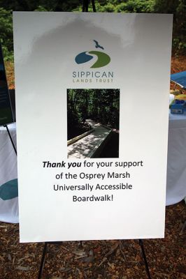 Osprey Marsh Accessible Boardwalk
Despite a downpour perfectly timed for its planned gathering on Friday off Point Road in Marion, the Sippican Lands Trust celebrated the completion of the new Osprey Marsh Accessible Boardwalk. Executive Director Jim Bride and president Alan Harris held a live Zoom meeting for those who could not attend, and some of the donors for the project assisted in the ribbon-cutting. The boardwalk is open by appointment. See story by Marilou Newell. Photo by Mick Colageo
