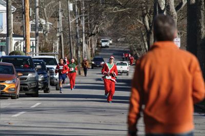 Santa Run 
Saturday, December 7, was the Santa Run 5k through the village of Mattapoisett. Usually held in New Bedford, race organizer Geoff Smith moved the race to Mattapoisett, flooding the village streets with hundreds of Santas – and a few Christmas miniature horses, as well. Photos by Jean Perry
