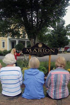 Welcome to Marion
Marion Garden Group member Elizabeth Hatch presents the town’s new sign on September 20 to a large gathering of residents at the Captain Hadley House property at the corner of Front Street and Route 6. The new sign was funded by the Town and is part of the garden group’s Marion beautification project. Photo by Jean Perry
