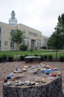 Sippican Elementary School
Colored stones sit atop and around the table-top tree stump at the center of the Memorial Garden in front of Sippican Elementary School. Photo by Mick Colageo
