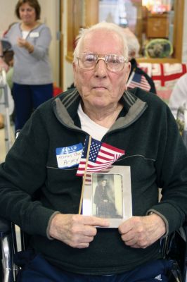 Veteran's Day
World War II Army Veteran Herman Bocks cradles an old photo and American flag during a Veterans Day event at Sippican Healthcare Center on November 3. Photo by Laura Pedulli. 
