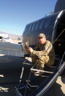 Afghanistan
Attached is a photo of Chief Warrant Officer 4 Dan Ferreira of Rochester while he catches up on hometown news prior to piloting a reconnaissance flight over Afghanistan.  
