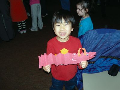 Chinese Culture
Children learned about Chinese culture and the Year of the Rabbit at a February 24, 2011 Mattapoisett library event. Librarian Linda Burke read a traditional Chinese story, and then the children enjoyed making their own dragons, watched as Haiying Zhang wrote their names in Mandarin, and tried eating fried rice with chopsticks. Photo by Anne Kakley.
