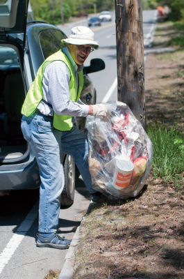 Clean Fun
Marion residents hit the street to pick up trash around town on Saturday, May 15. All over Marion, there were people in day-glo vests working with Manducas, long pincers made by Marion resident Eunice Manduca for picking up trash. The collected trash was placed in front of the Marion Music Hall to create Trash Bag Mountain. Photos by Felix Perez. May 20, 2010 edition
