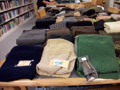 Scarves for the Troops
More than 180 scarves knitted by locals filled tables at Rochester Plumb Library. The scarves  destined for soldiers deployed in Afghanistan  were delivered to the United Services Organization, which assembled them into Care Packages just in time for winter. Photo courtesy of Gail Roberts
