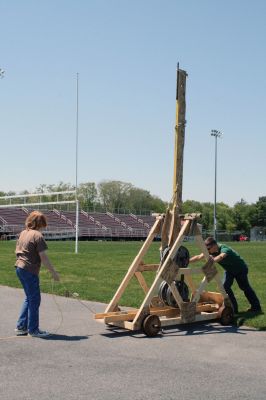 Trebuchet Time
Senior Carl Dias and freshman Callum McLaughlin from Old Rochester Regional High Schools engineering class constructed this large working trebuchet with guidance from their teacher Tom Norris. The trebuchet was tested in the football fields with gallons of water, a rock and a watermelon. Delightful throwing and smashing ensued. Photo by Anne OBrien-Kakley.
