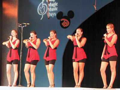 Magic Memories
The Showstoppers, the popular Mattapoisett-based singing troupe, just returned from a trip to Disney World in Orlando, FL, where they performed at the theme park as part of Disneys Magic Music Days on August 5. The group performed at the Galaxy Palace Theater located in Tomorrowland inside Disneys Magic Kingdom. In addition to the stage performance, they also participated in Disneys Show Choir Magic  A Performing Arts Workshop in a backstage rehearsal hall in Epcot Center. (Photo by Kelly Zucco).
