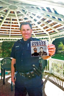 Blues From Man in Blue
Rochester Police Officer Johnny Barnes, who is also the author of two self-published murder mysteries, poses with a copy of his new CD, Known Offenders, which collects both brand new and previously-released material from his heyday as an active member of the Boston music scene. The music can best be described as blues-flavored-rock, akin to The Rolling Stones and Stevie Ray Vaughan. The busy patrolman is also currently working on his third novel, tentatively titled Dead on the Internet. (Photo by Kenneth J. Souza).
